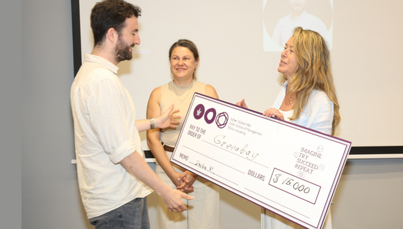 Sofaer Global MBA alum Daniel Odesser of Greenbay receives one of the Sofaer Pitch Competition prizes from Prof. Jackie Goren