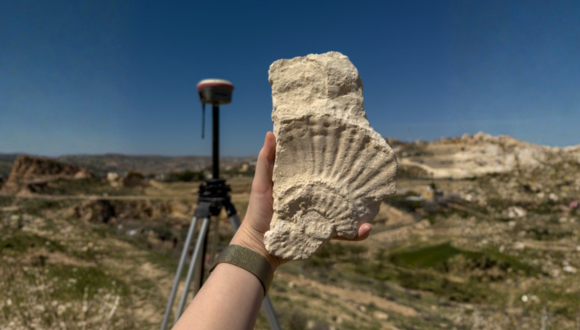 Jianlian shows one of the finds at an archaeological excavation in Israel