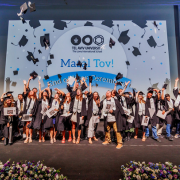 International graduates toss their caps onstage at Tel Aviv University’s 2026 Lowy International School graduation ceremony.