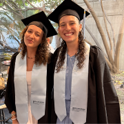 Two TAU's 2026 BA graduates in graduation gowns
