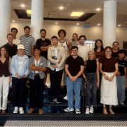 Chinese and Israeli participants in a RExPA student gathering pose together on indoor steps at Tel Aviv University.